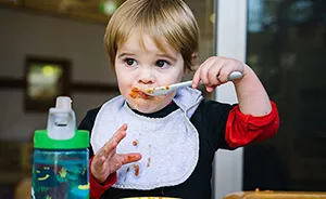 Young boy eating from spoon