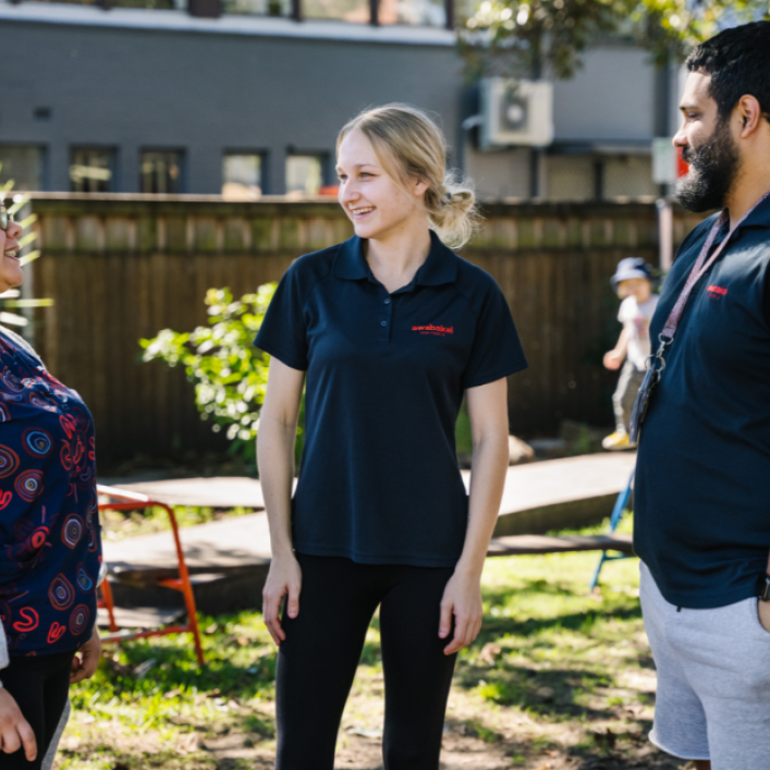 Three educators talking outside